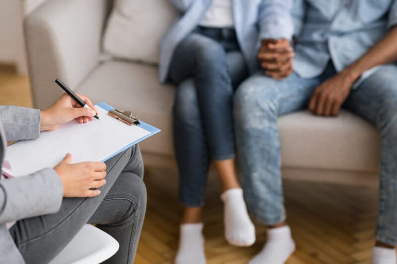Couple holding hands during marital therapy